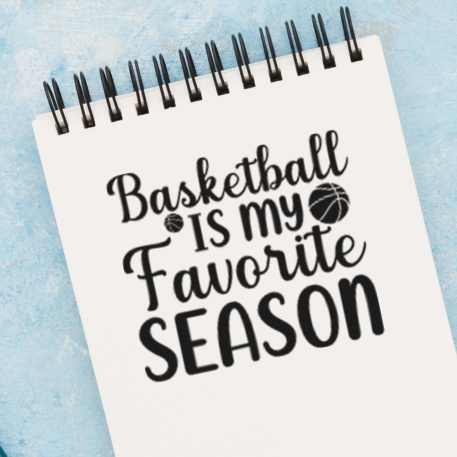 Basketball is my favorite season rubber stamp design on a spiral notebook, perfect for sports-themed crafts and planners.