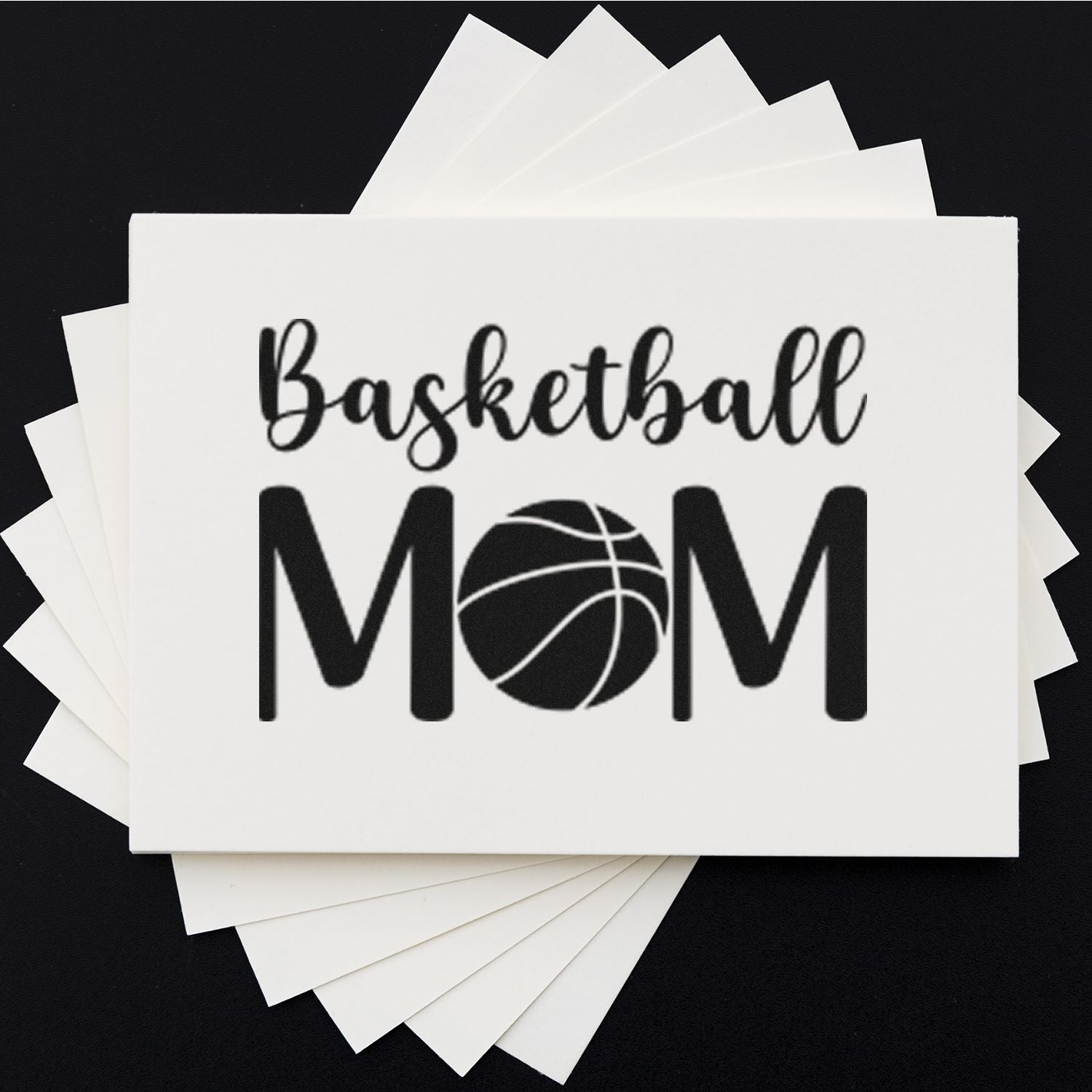 Basketball Mom custom rubber stamp design on stacked white paper, perfect for sports crafts and personalized gifts.
