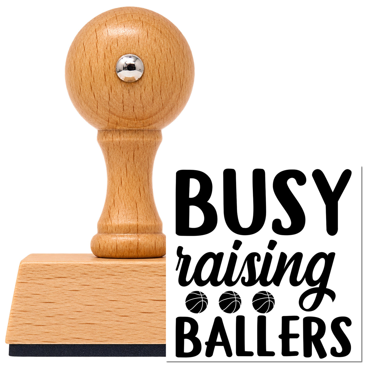 Busy Raising Ballers Quote Vintage Pro rubber stamp in European beech wood with a round knob handle, shown beside its black imprint.