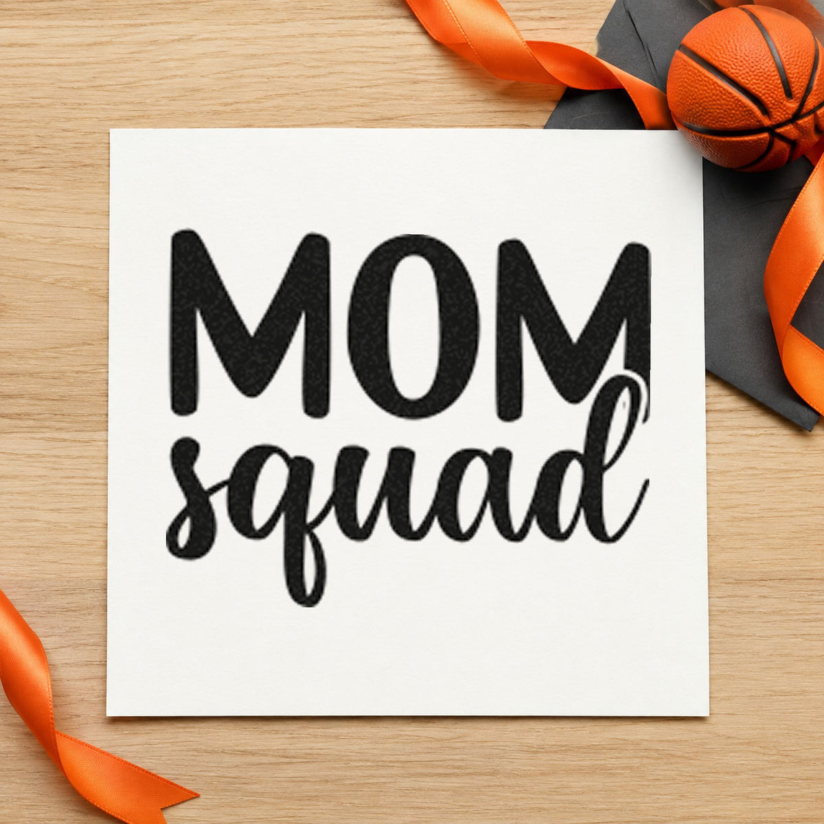 Mom Squad Bold Script craft stamp imprint in black ink on a handmade project, one idea being matching shirt tags.