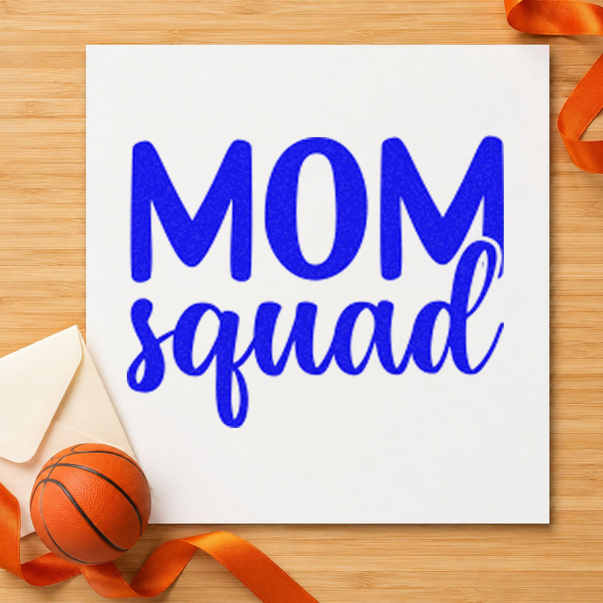 Mom Squad Bold Script craft stamp in blue ink on cardstock, an easy option for group tee printing.