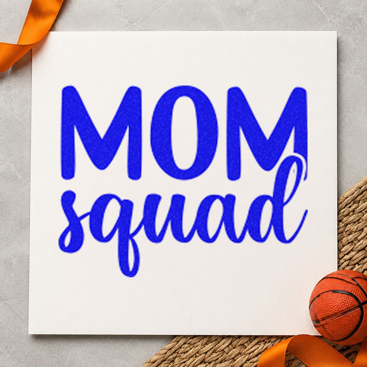 Mom Squad Bold Script craft stamp imprinted in blue ink on paper, a design suited to framed kitchen nook.