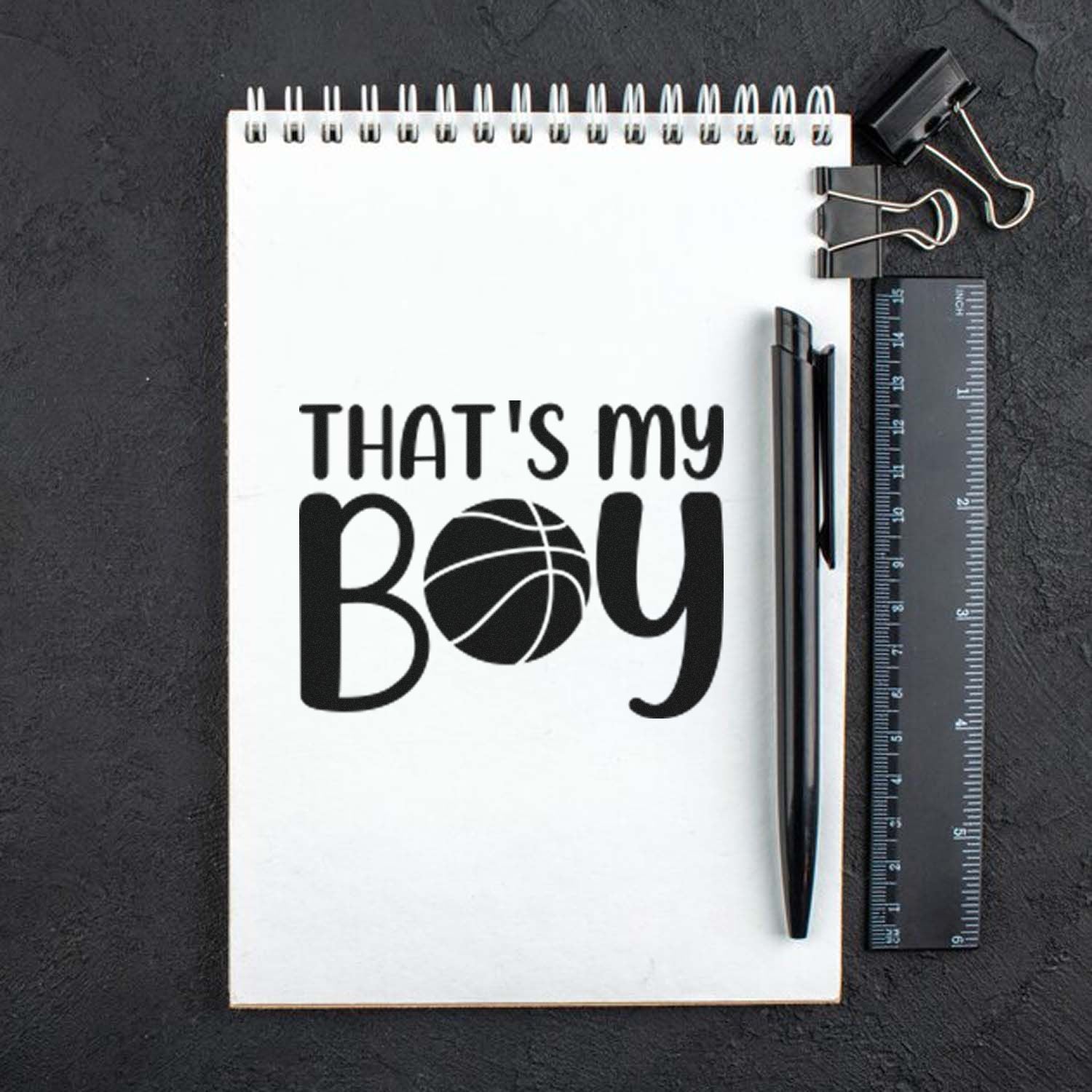 Basketball Thats My Boy rubber stamp design on notebook mockup for sports-themed cards, scrapbooking, and gifts.