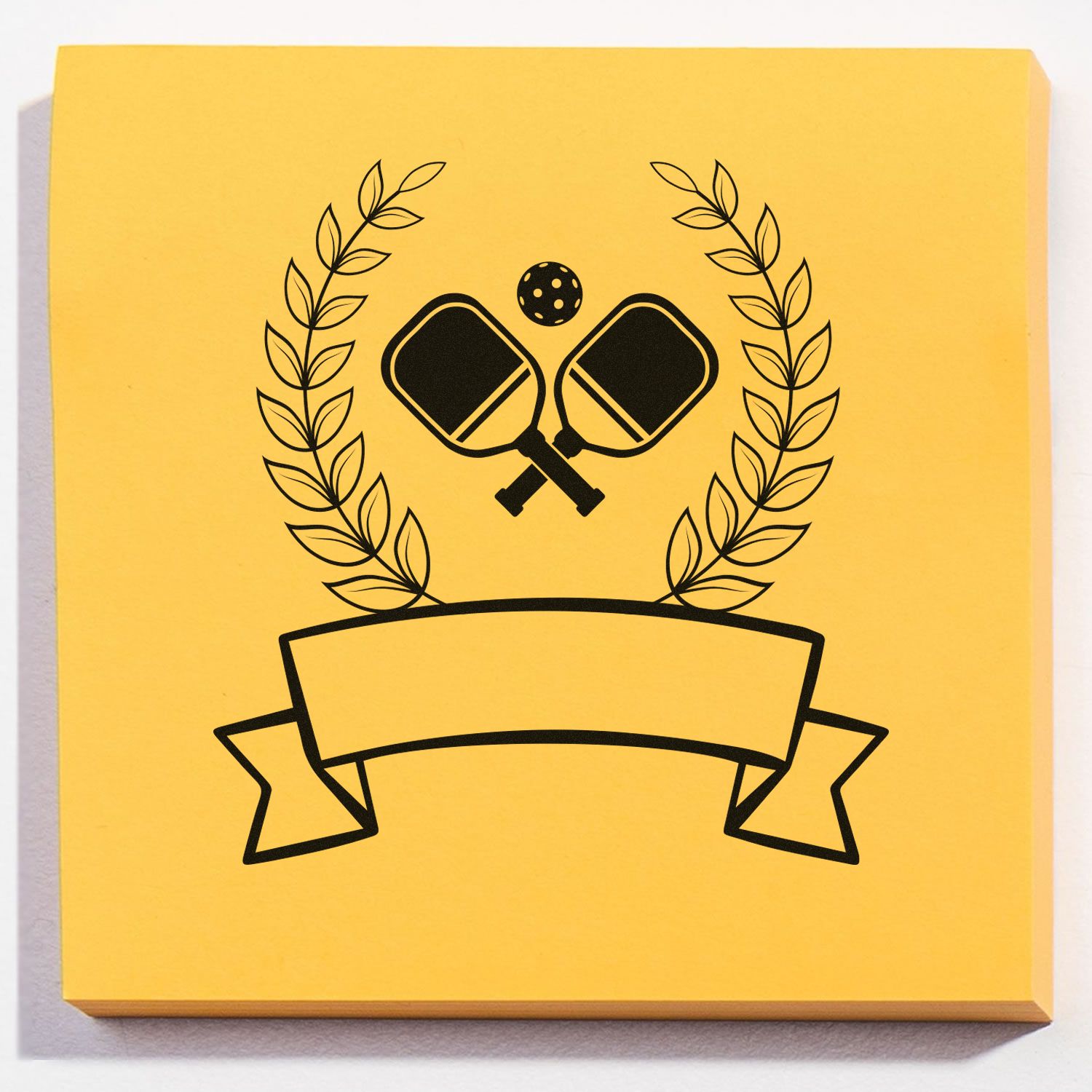 Custom pickleball rubber stamp design featuring crossed paddles, laurel wreath, and blank banner on yellow paper