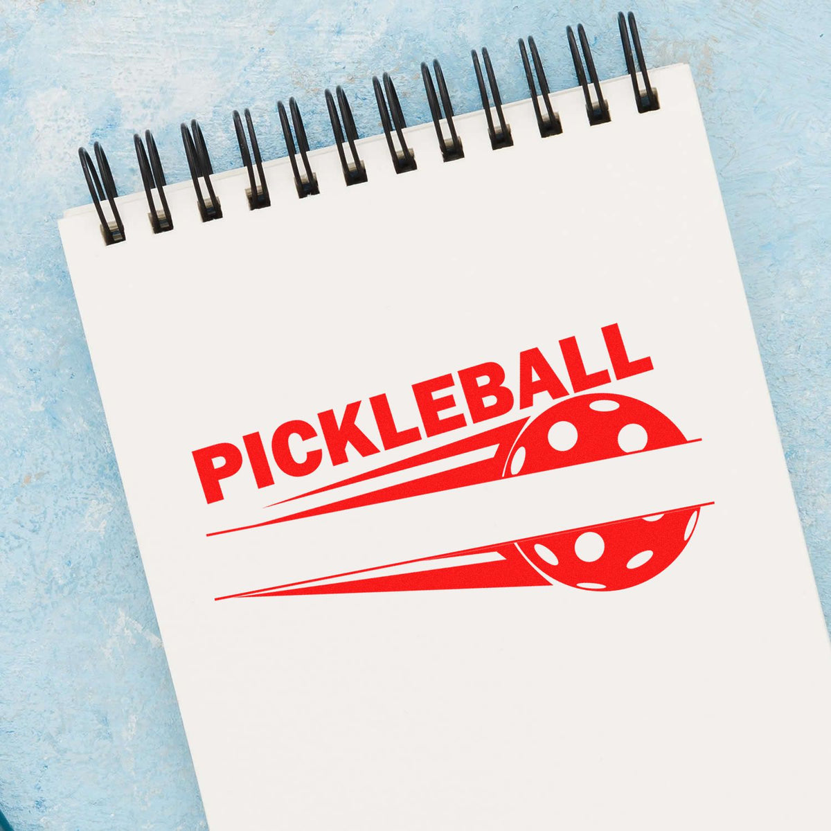 Pickleball rubber stamp design on notepad with red paddle and ball graphic