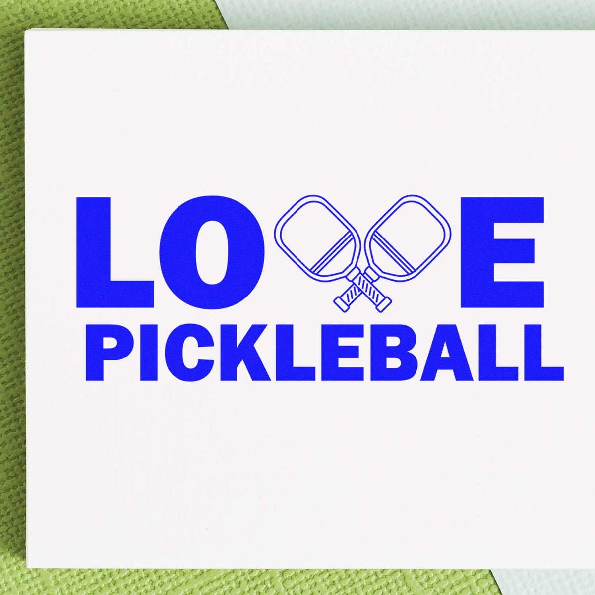 Love Pickleball rubber stamp design with crossed paddles, perfect for sports-themed crafts, cards, and handmade projects.