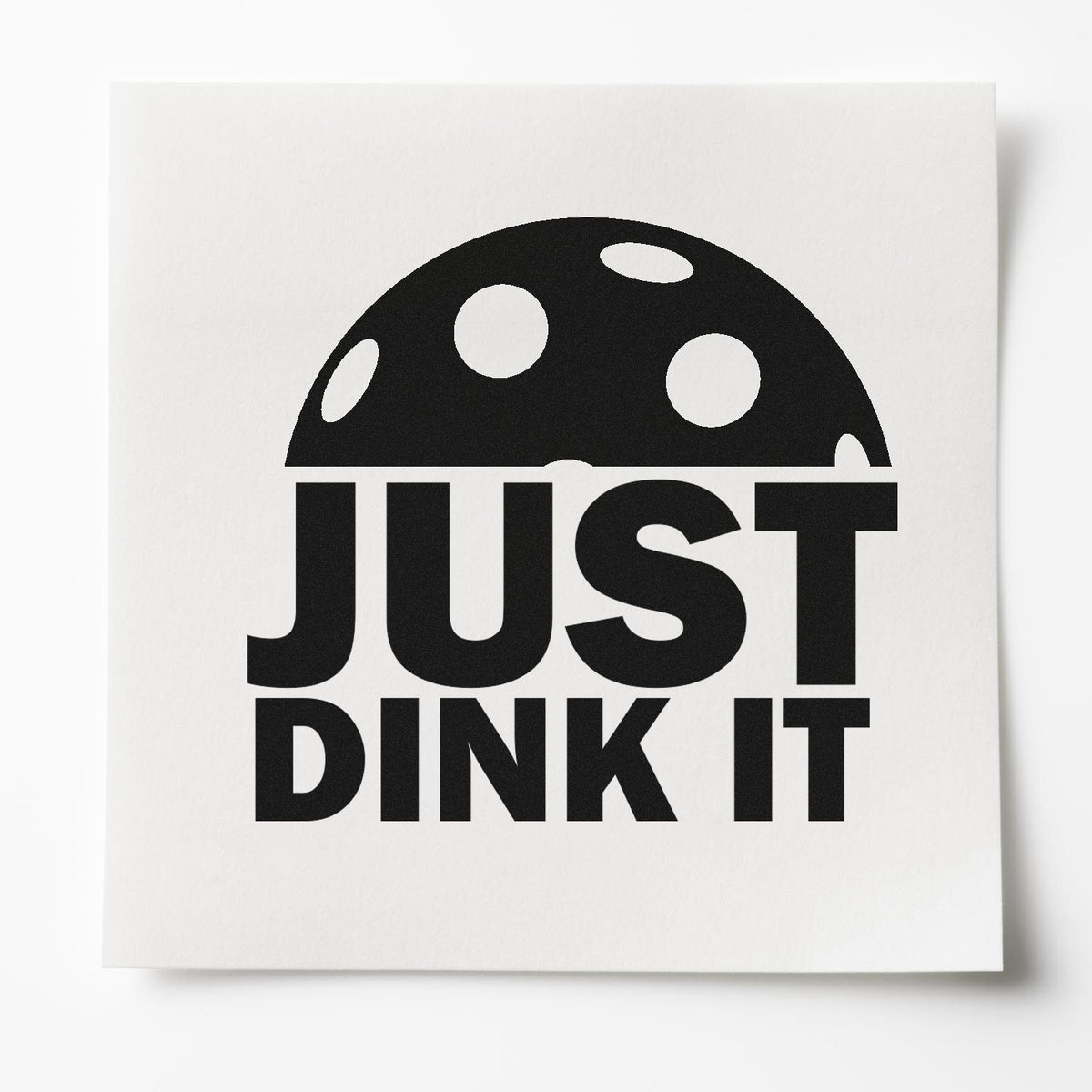 Pre-Inked Just Dink It Ball Lettering Stamp – PSI imprint stamped in black ink. A large half pickleball sits above the bold words JUST DINK IT.