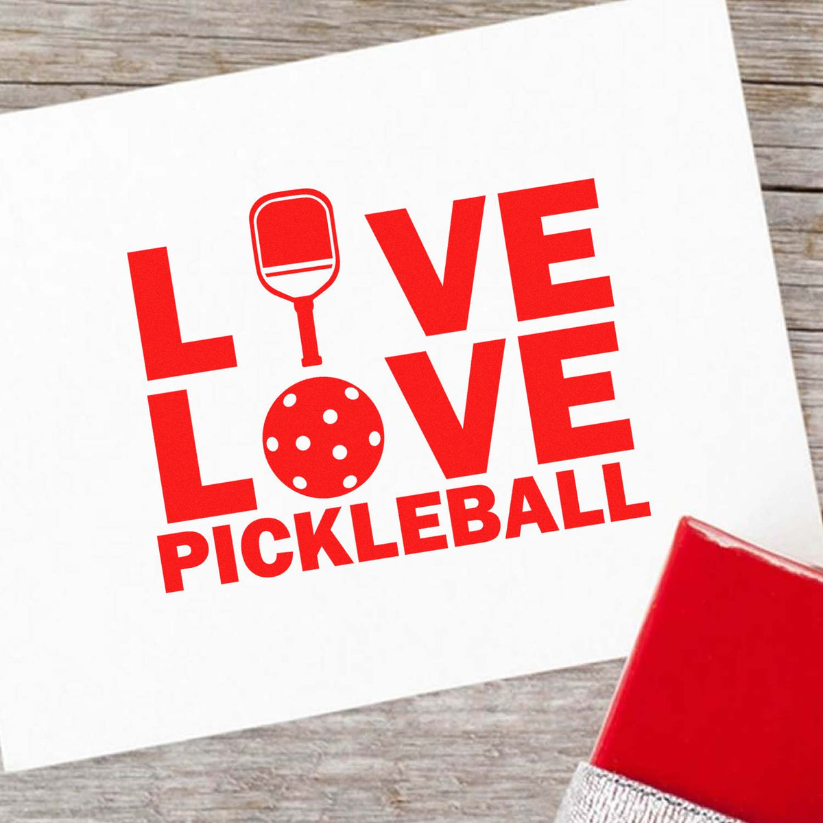 Custom pickleball love rubber stamp design with paddle and ball graphic on a greeting card.