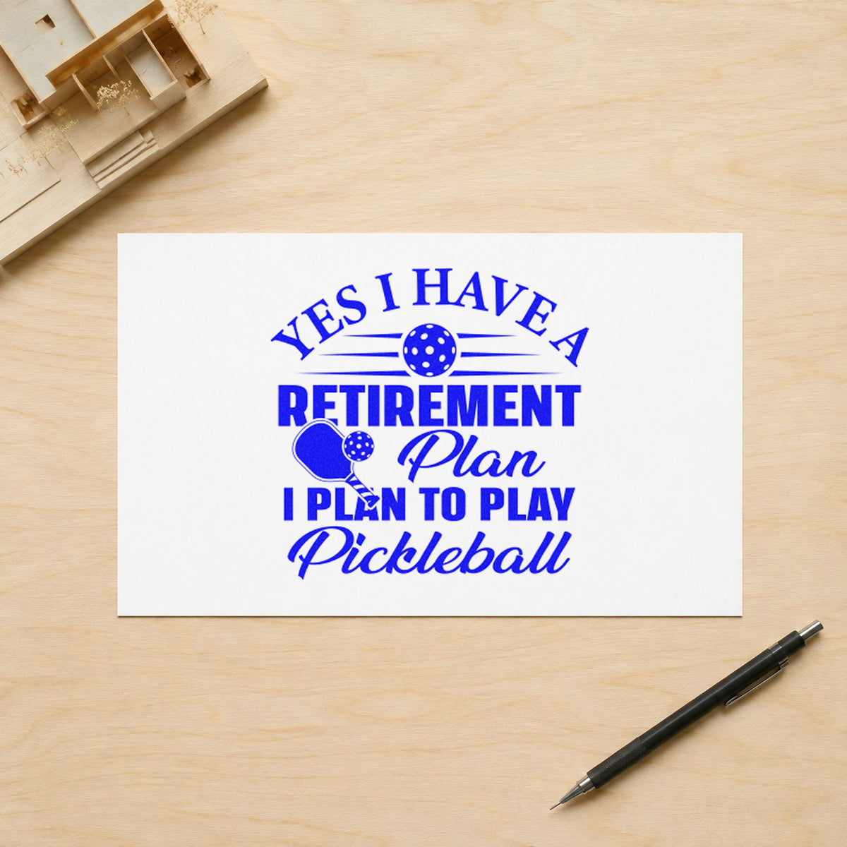 Retirement Plan Play Pickleball craft stamp imprinted in blue ink on paper, a design suited to framed guest table.