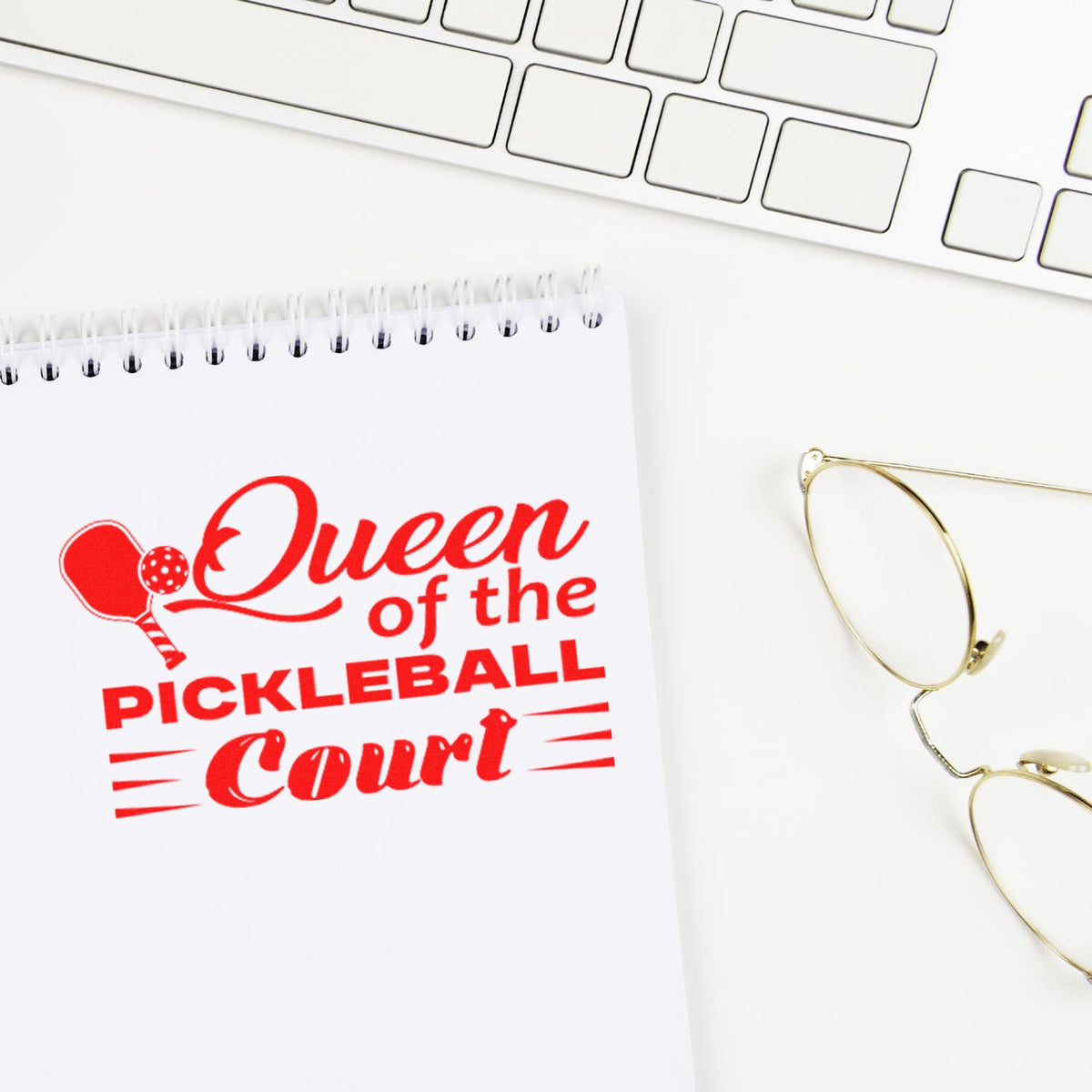 Custom rubber stamp impression reading Queen of the Pickleball Court on notebook, ideal for pickleball gifts and sports branding.