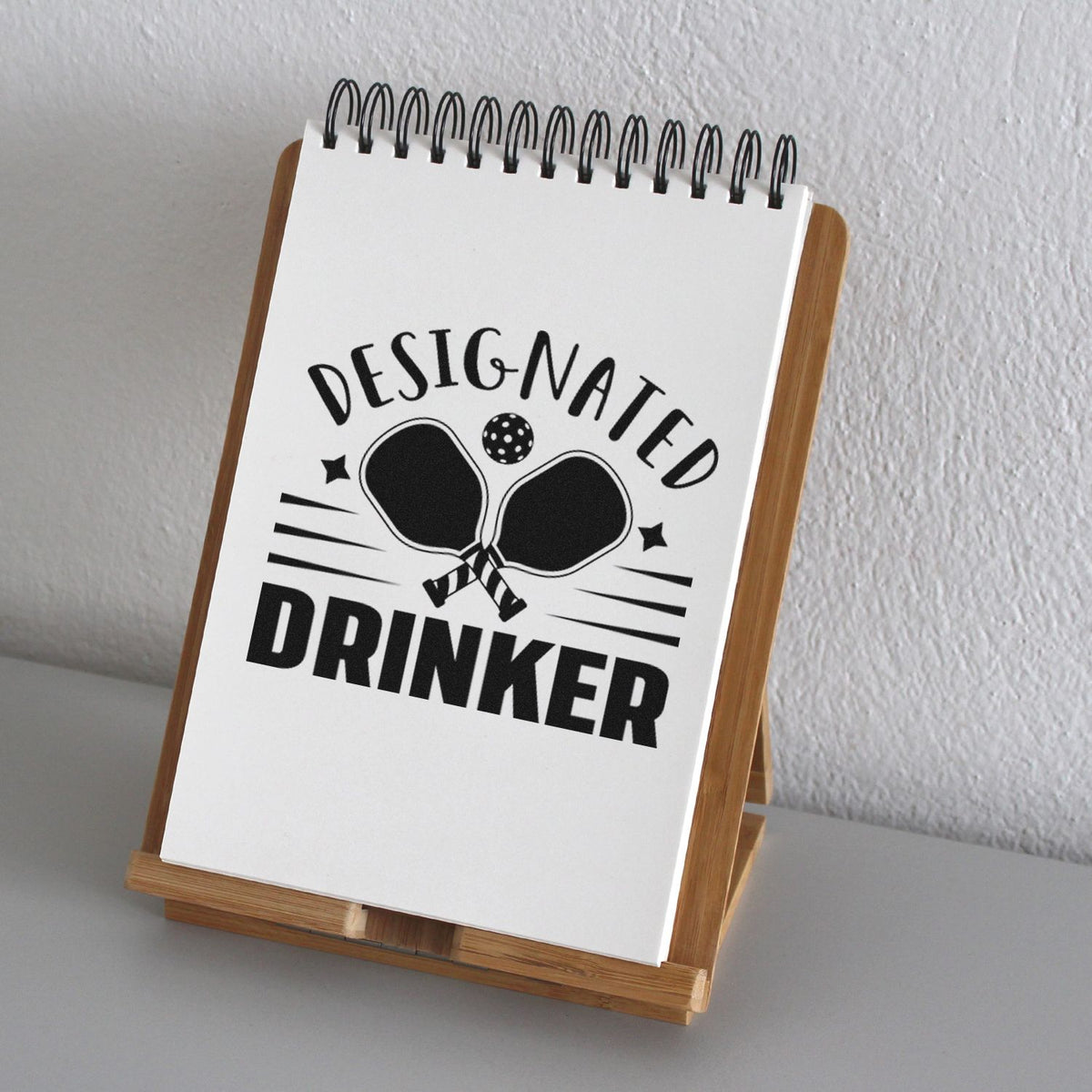 Designated Drinker rubber stamp design with ping pong paddles, ideal for party invitations and novelty stamping.
