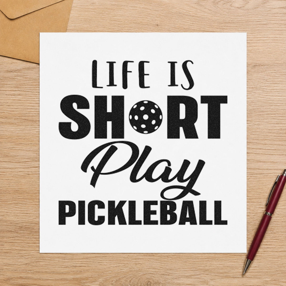Life Short Play Pickleball craft stamp imprint in black ink on a handmade project, one idea being travel paddle tags.
