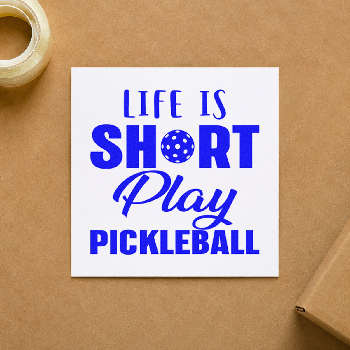 Life Short Play Pickleball craft stamp imprinted in blue ink on paper, a design suited to framed cabin wall.