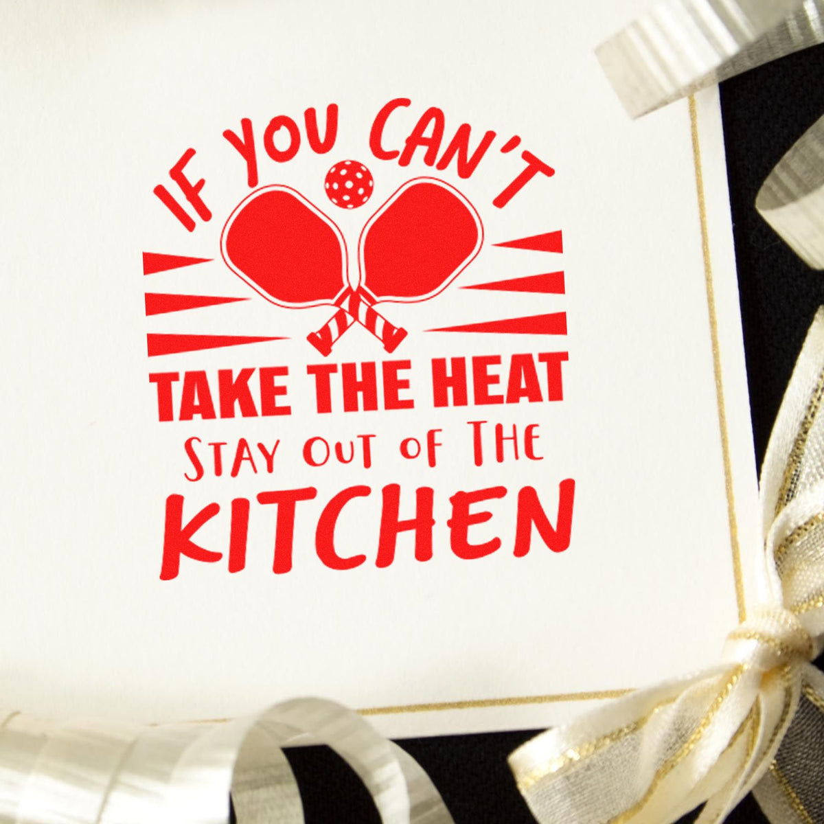 Red custom rubber stamp impression with tennis paddles and quote, If you cant take the heat, stay out of the kitchen.