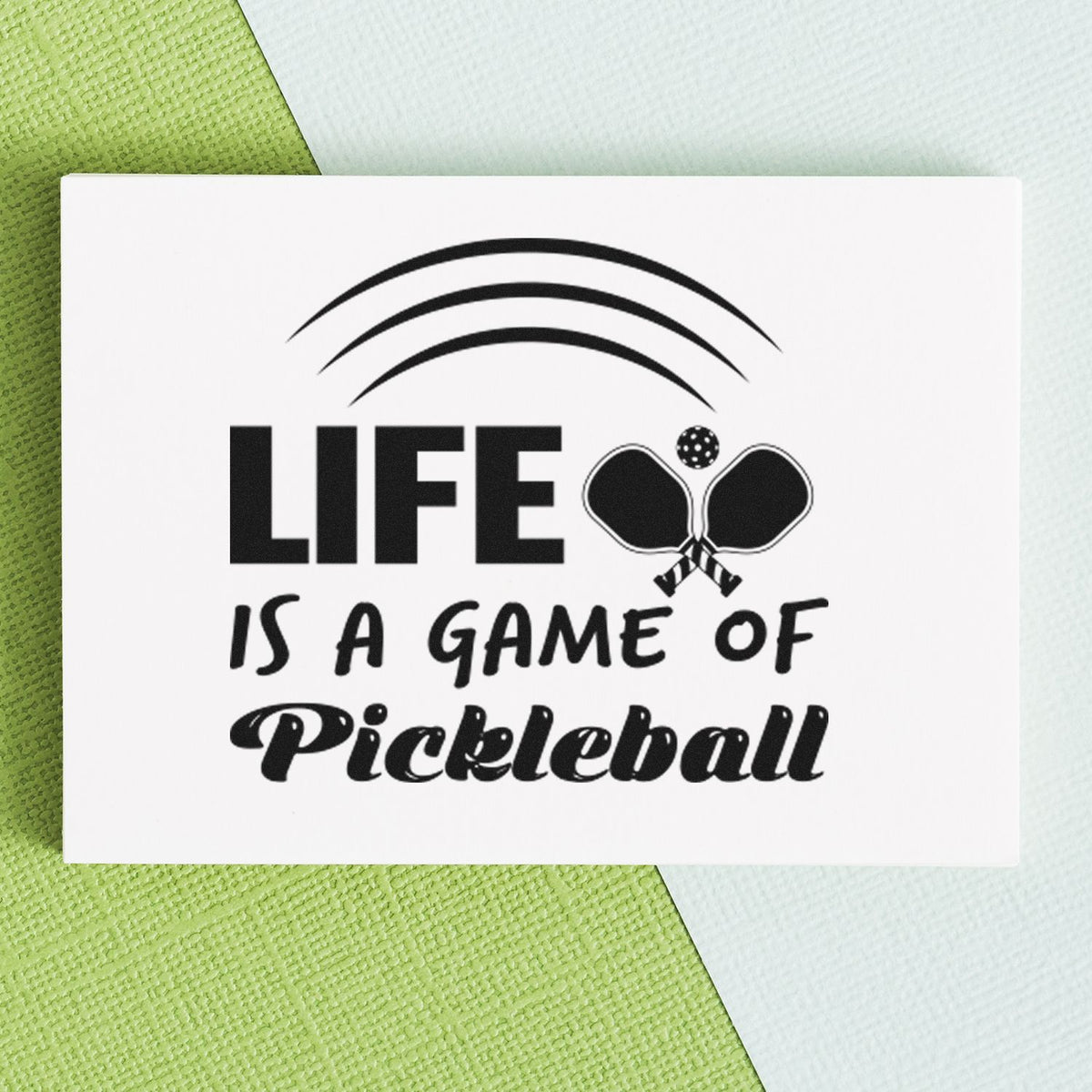 Life Game Of Pickleball Pre-Inked Stamp – PSI imprint stamped in black ink. LIFE IS A GAME OF Pickleball appears with crossed paddles and three curved lines above.