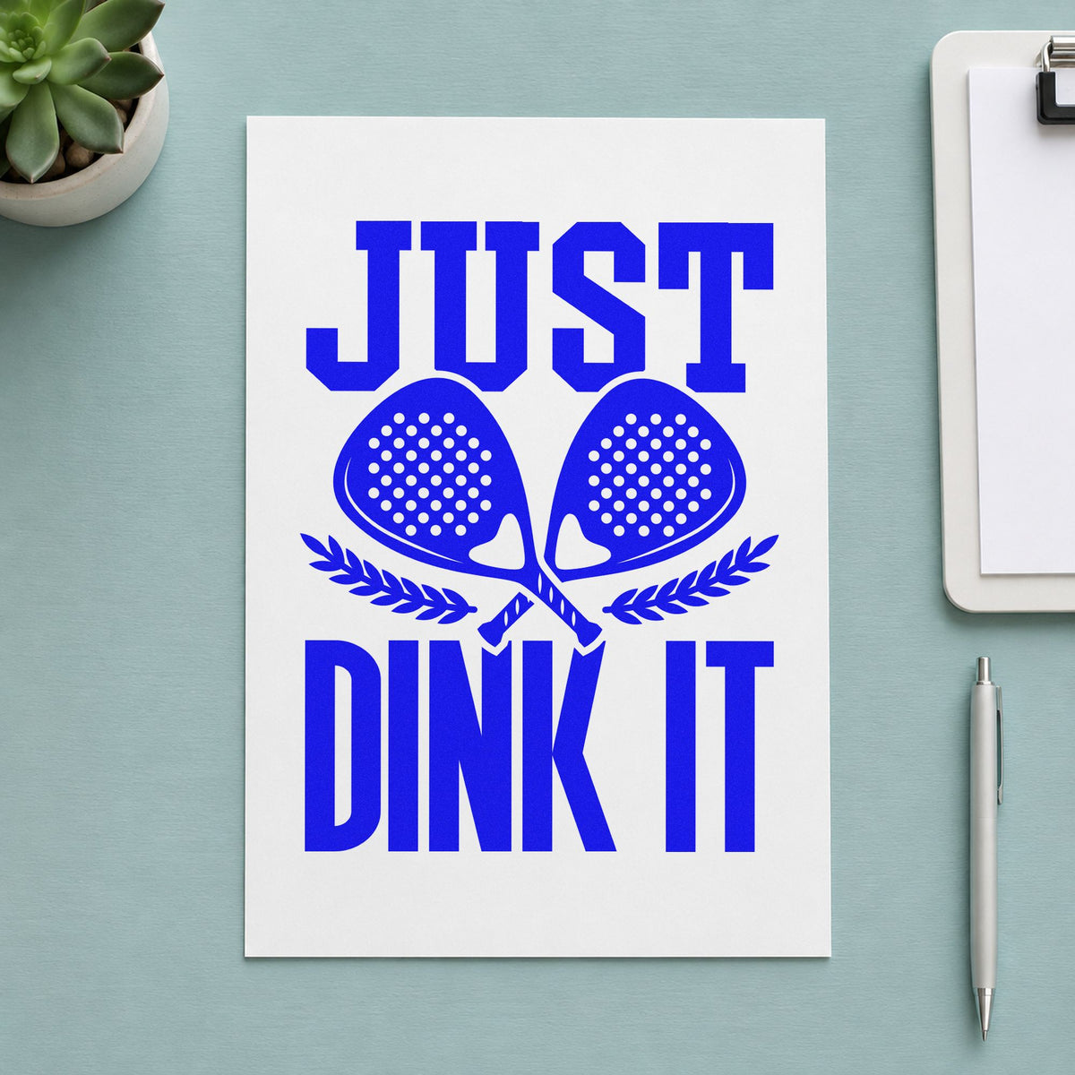 Just Dink It Laurels craft stamp imprinted in blue ink on paper, a design suited to framed park shelter.