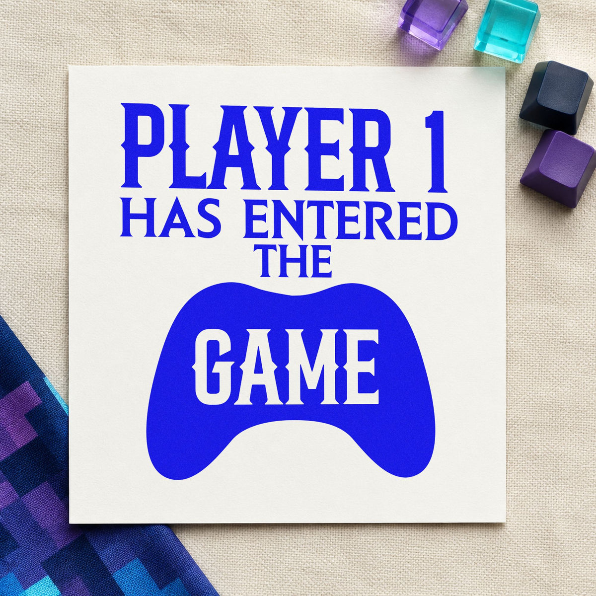 Player One Entered Game craft stamp in blue ink on cardstock, an easy option for nursery blanket printing.