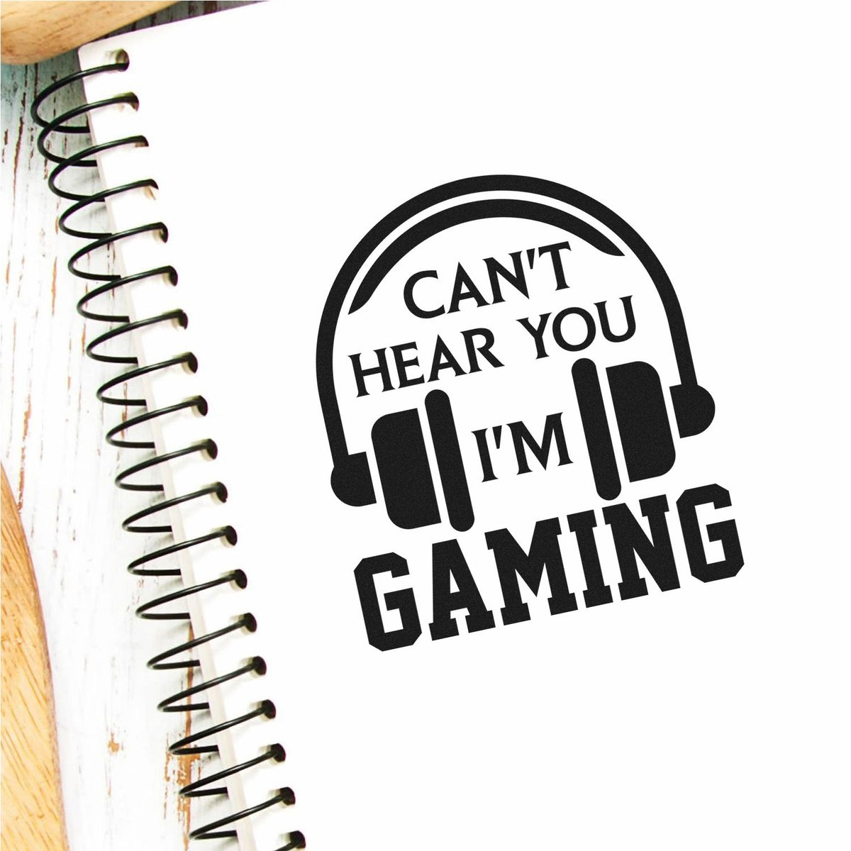 Funny gaming rubber stamp design with headset icon and Cant Hear You Im Gaming text for crafts, notebooks, and gifts.