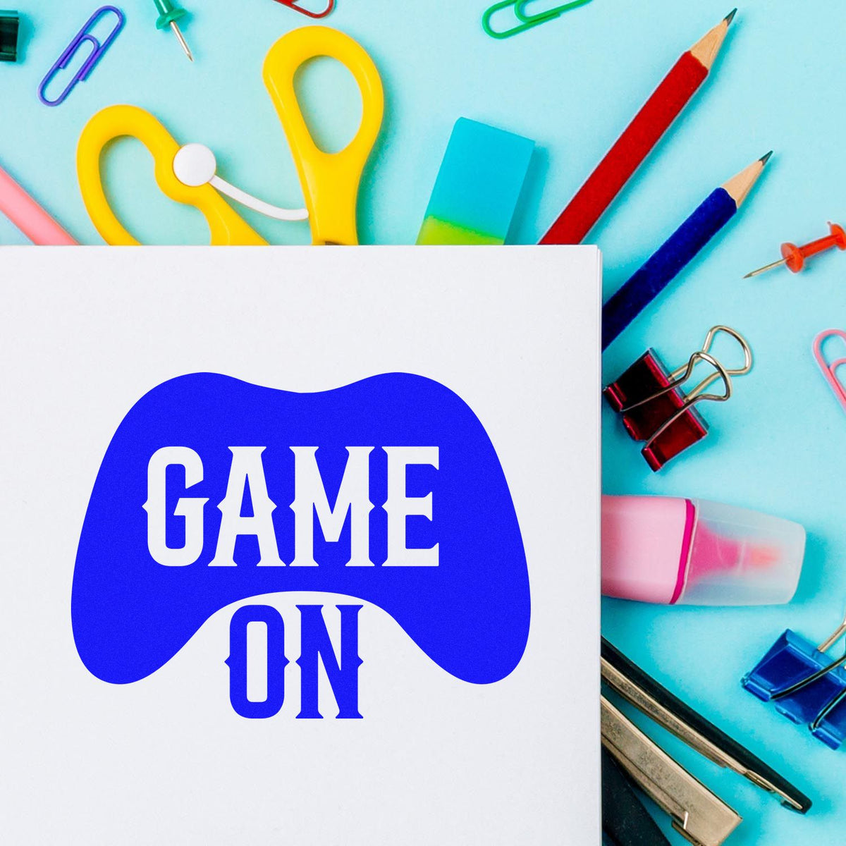 Game On rubber stamp design on paper with colorful school supplies, ideal for classroom crafts, gaming themes, and custom stamps.