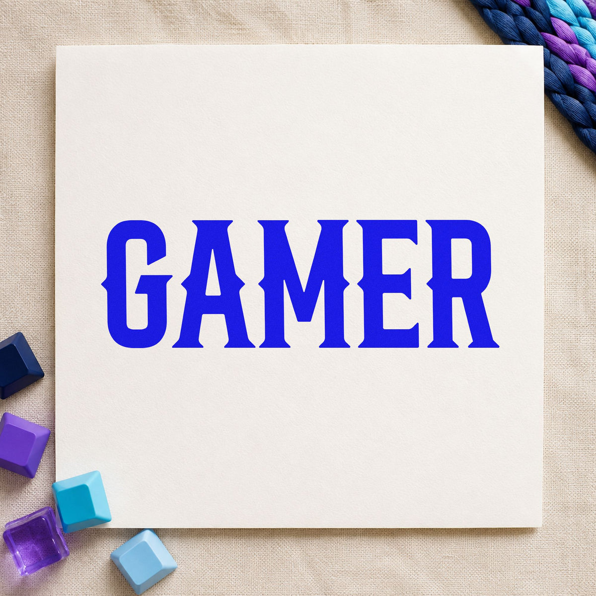Gamer Bold Slab Lettering craft stamp in blue ink on cardstock, an easy option for press apron printing.