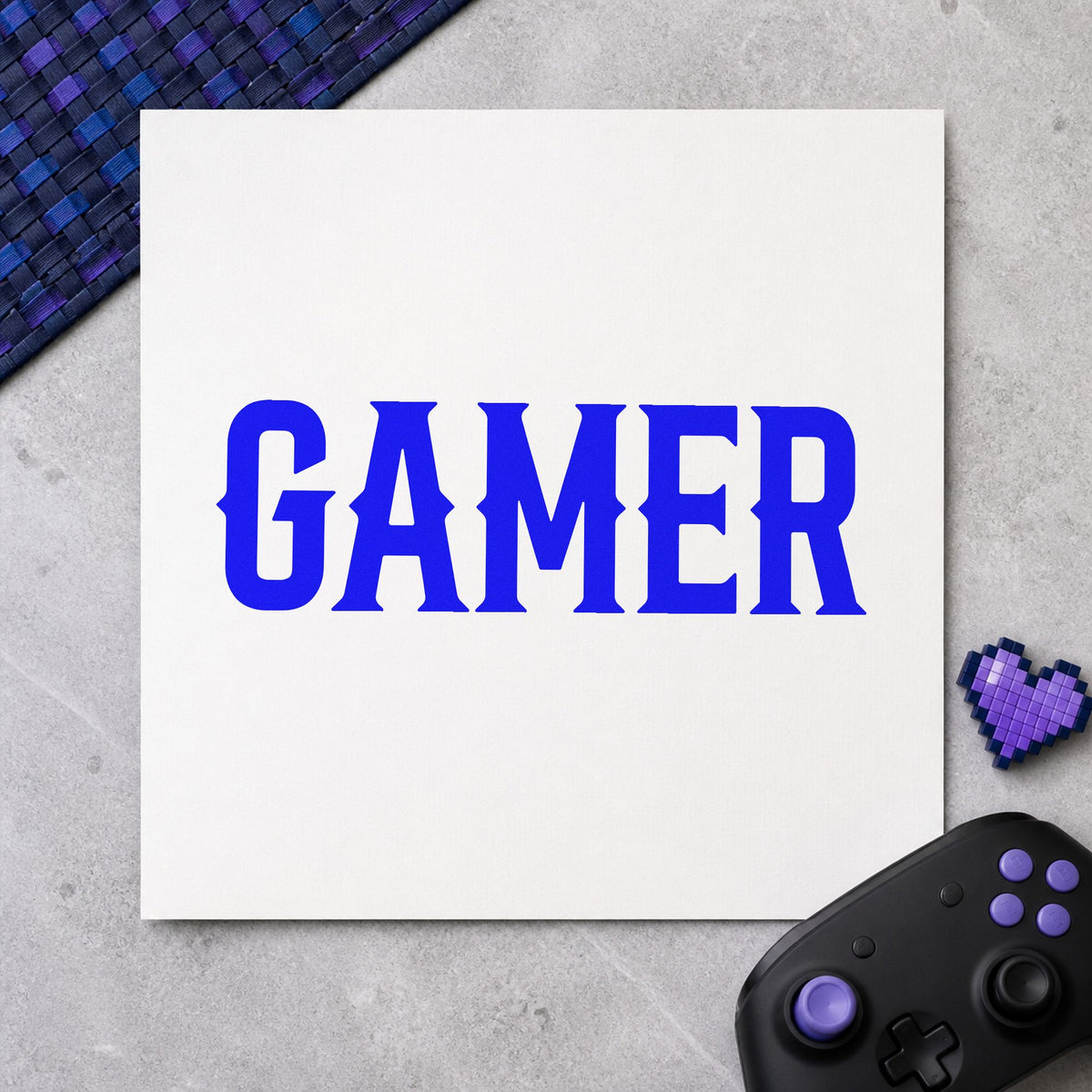 Gamer Bold Slab Lettering craft stamp imprinted in blue ink on paper, a design suited to framed press room.