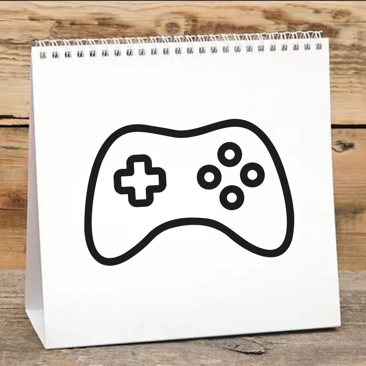 Ring Button Controller Outline Pre-Inked Stamp – PSI imprint stamped in black ink. A rounded controller outline contains a directional cross and four ring-shaped buttons.