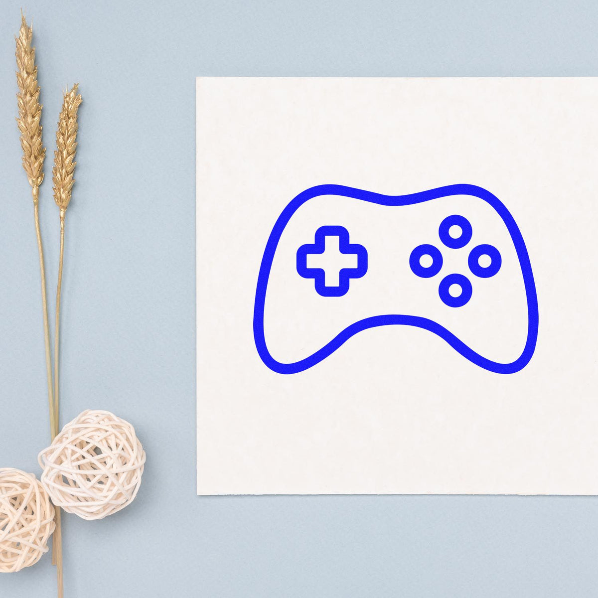 Simple Outlined Game Controller rubber stamp shown in blue ink, stamped for projects such as library club album page.