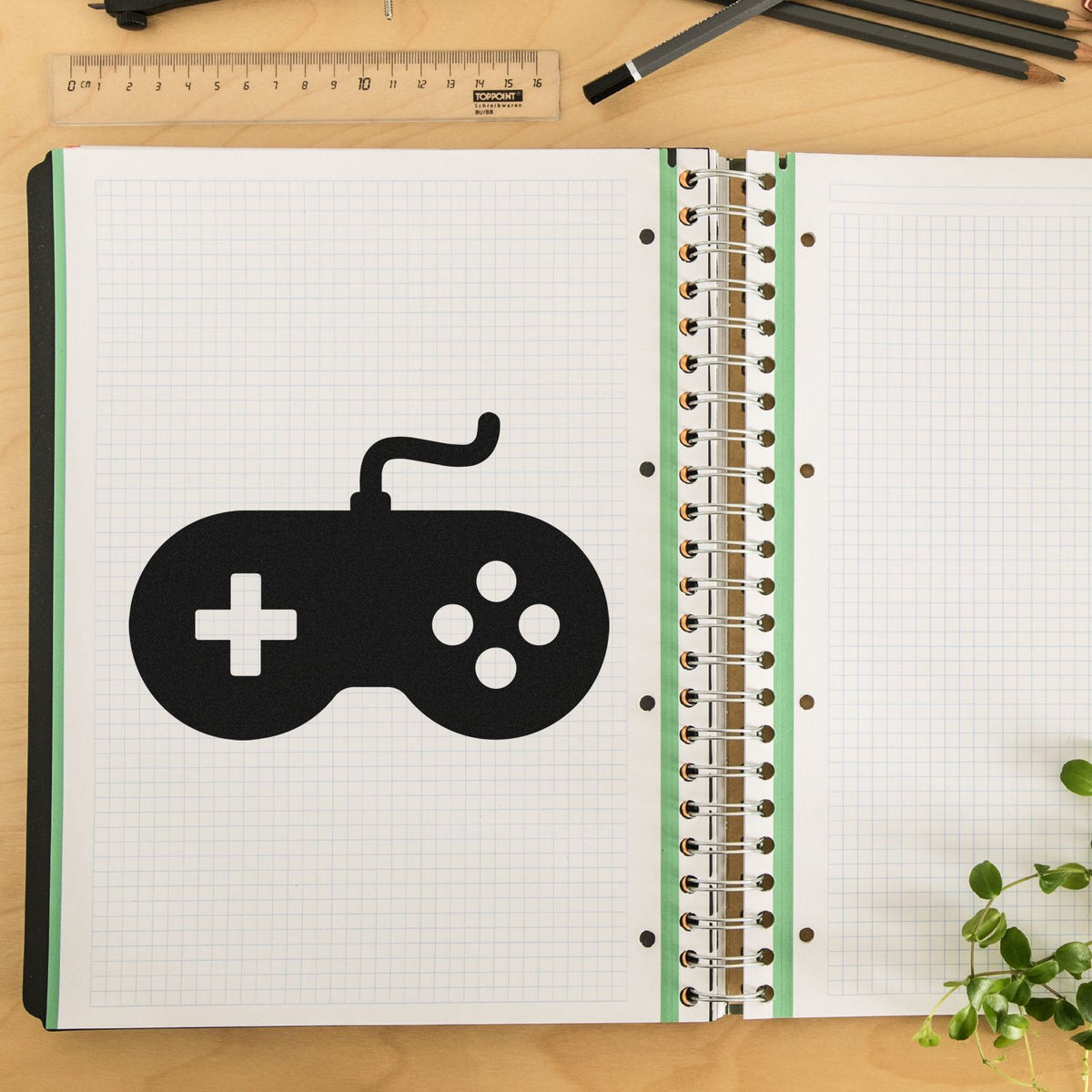 Custom video game controller rubber stamp design in a spiral notebook planner