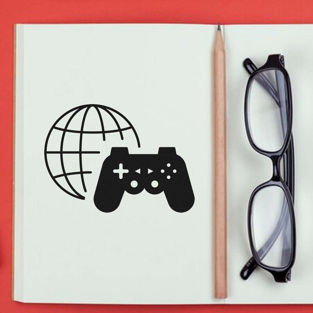 Custom rubber stamp design with globe and game controller icons on a notebook page, ideal for branding or creative projects
