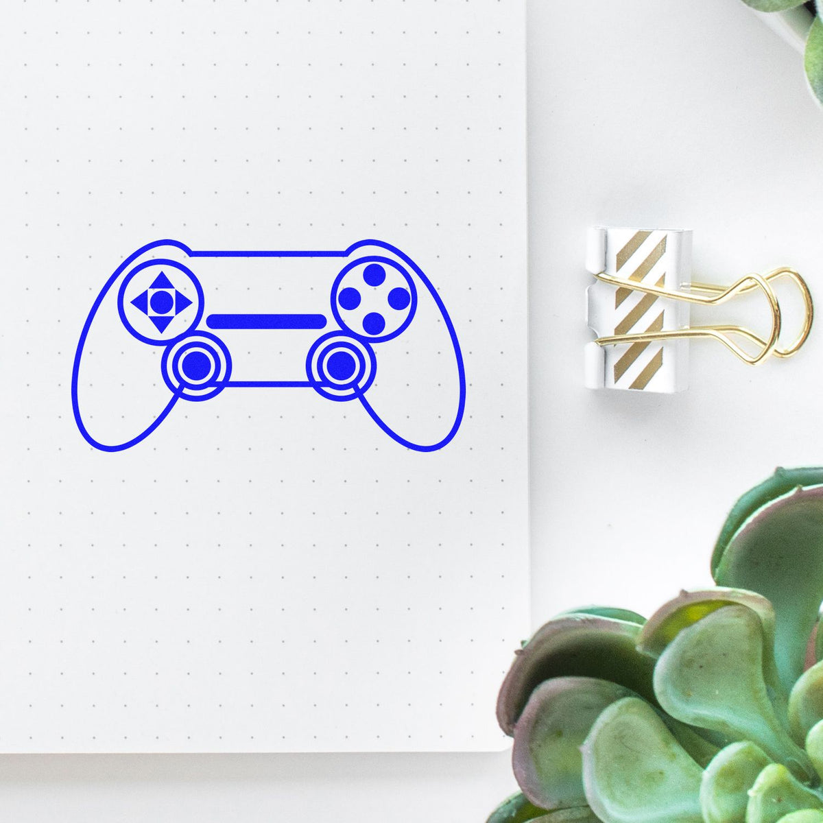 Video game controller rubber stamp for bullet journals, planner pages, and gamer-themed craft projects.