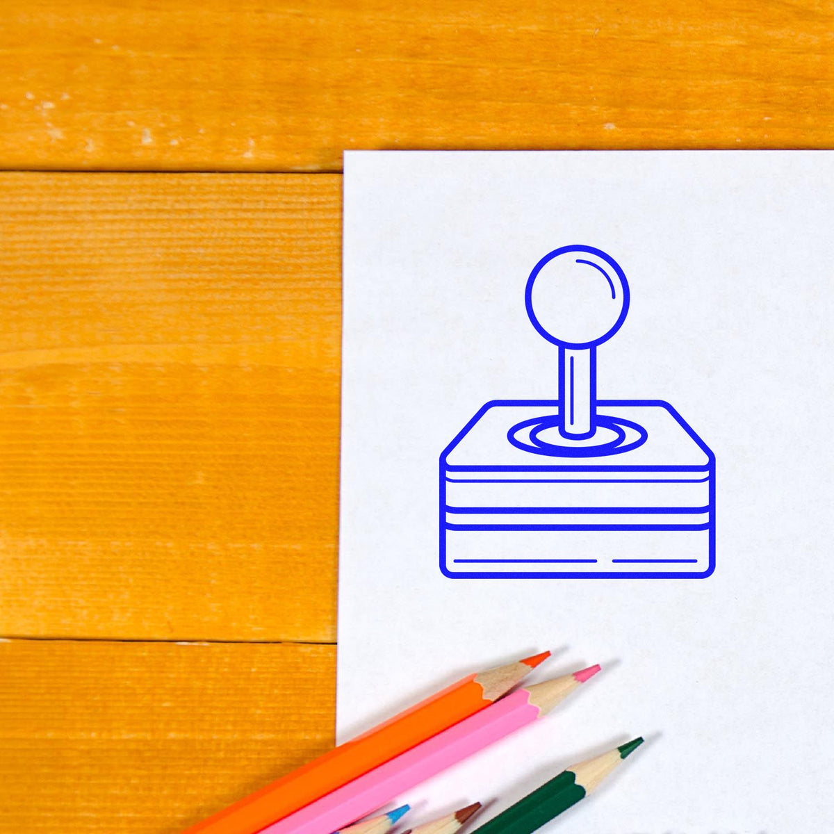 Blue rubber stamp icon on white paper with colored pencils, ideal for custom office stamp and branding design.