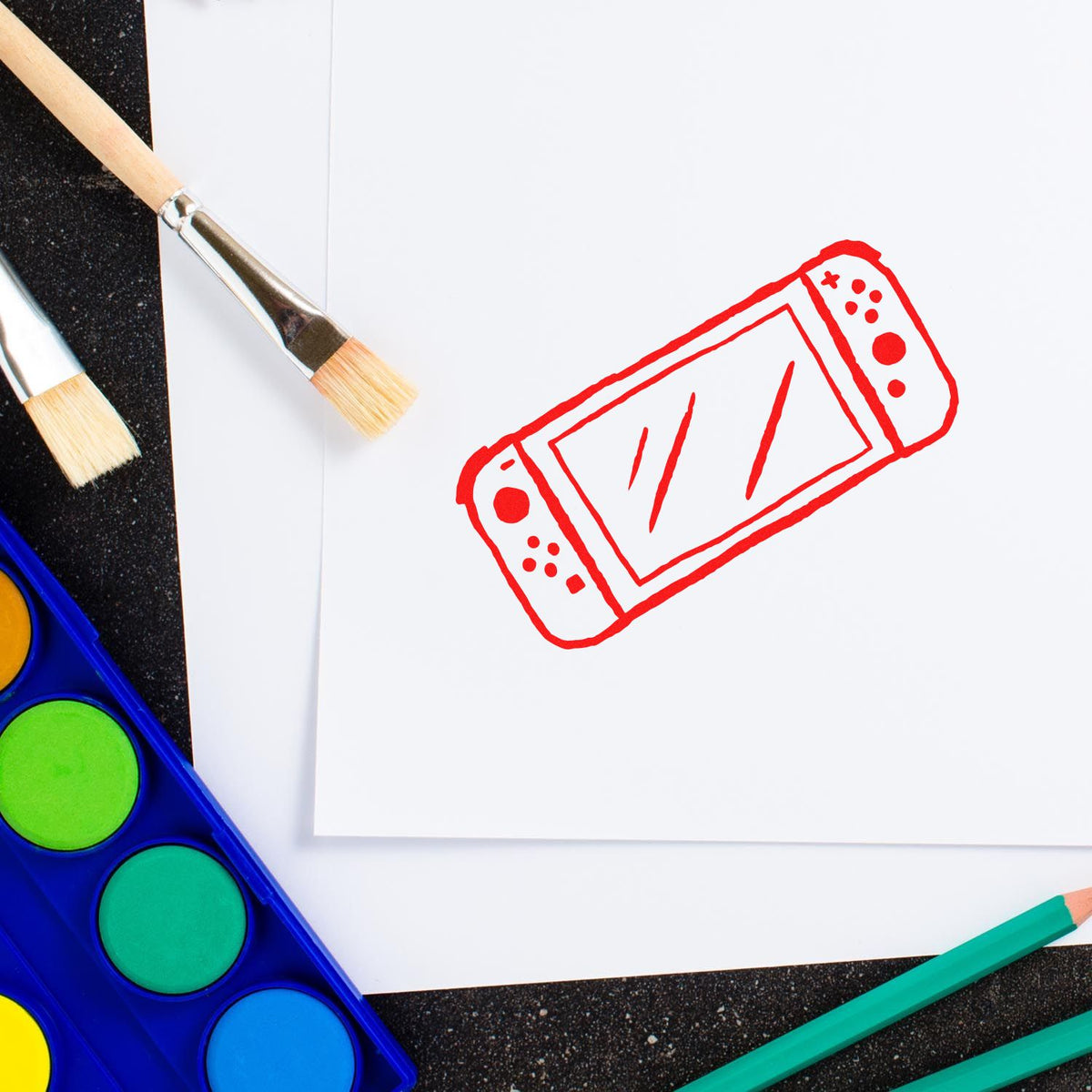 Handheld Gaming Console Outline rubber stamp shown in red ink, stamped for projects such as journey album page.