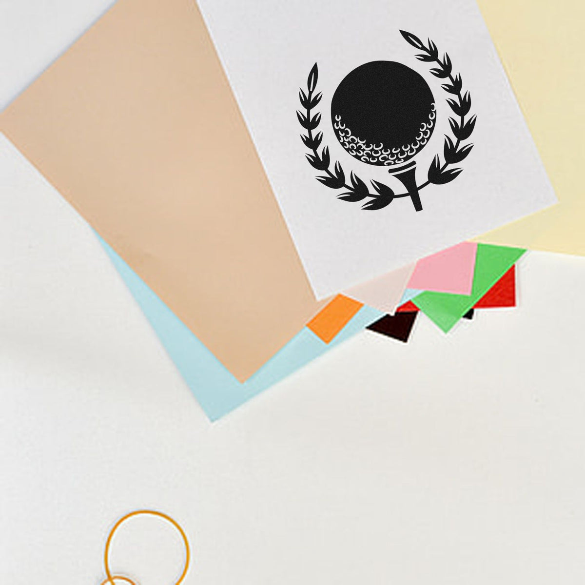 Custom golf ball rubber stamp imprint on paper swatches, showing logo branding for personalized stationery and packaging.