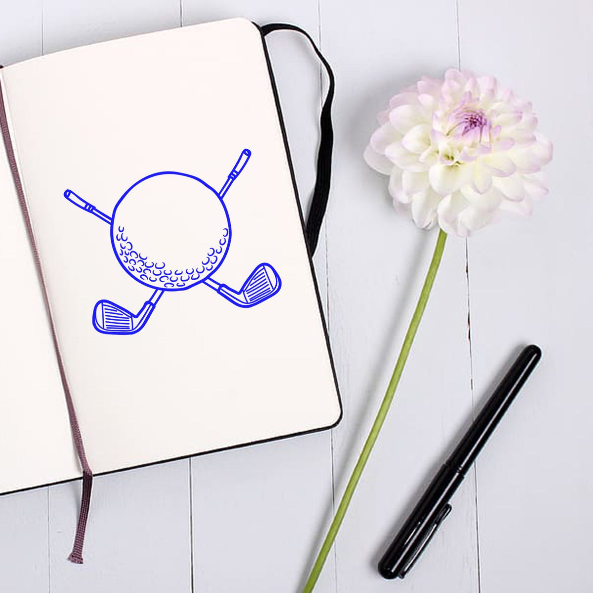 Golf ball and clubs rubber stamp design on notebook, ideal for sports-themed custom stamping and golf gifts