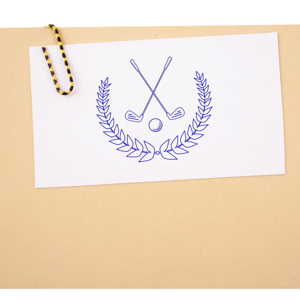 Custom golf rubber stamp design with crossed clubs, golf ball, and laurel wreath on a paper mockup