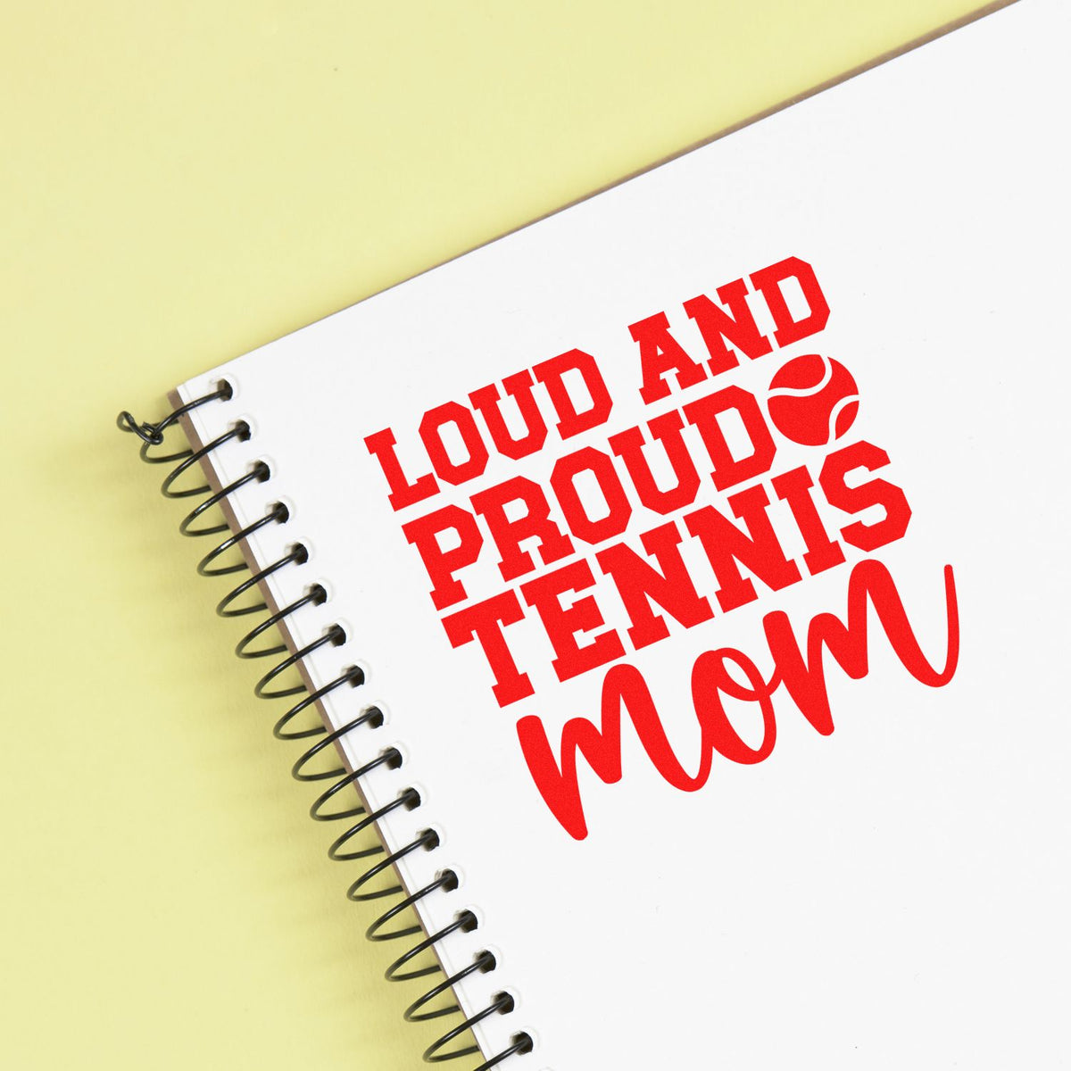 Loud and Proud Tennis Mom rubber stamp design on a spiral notebook, ideal for custom tennis mom gifts, crafts, and stationery.