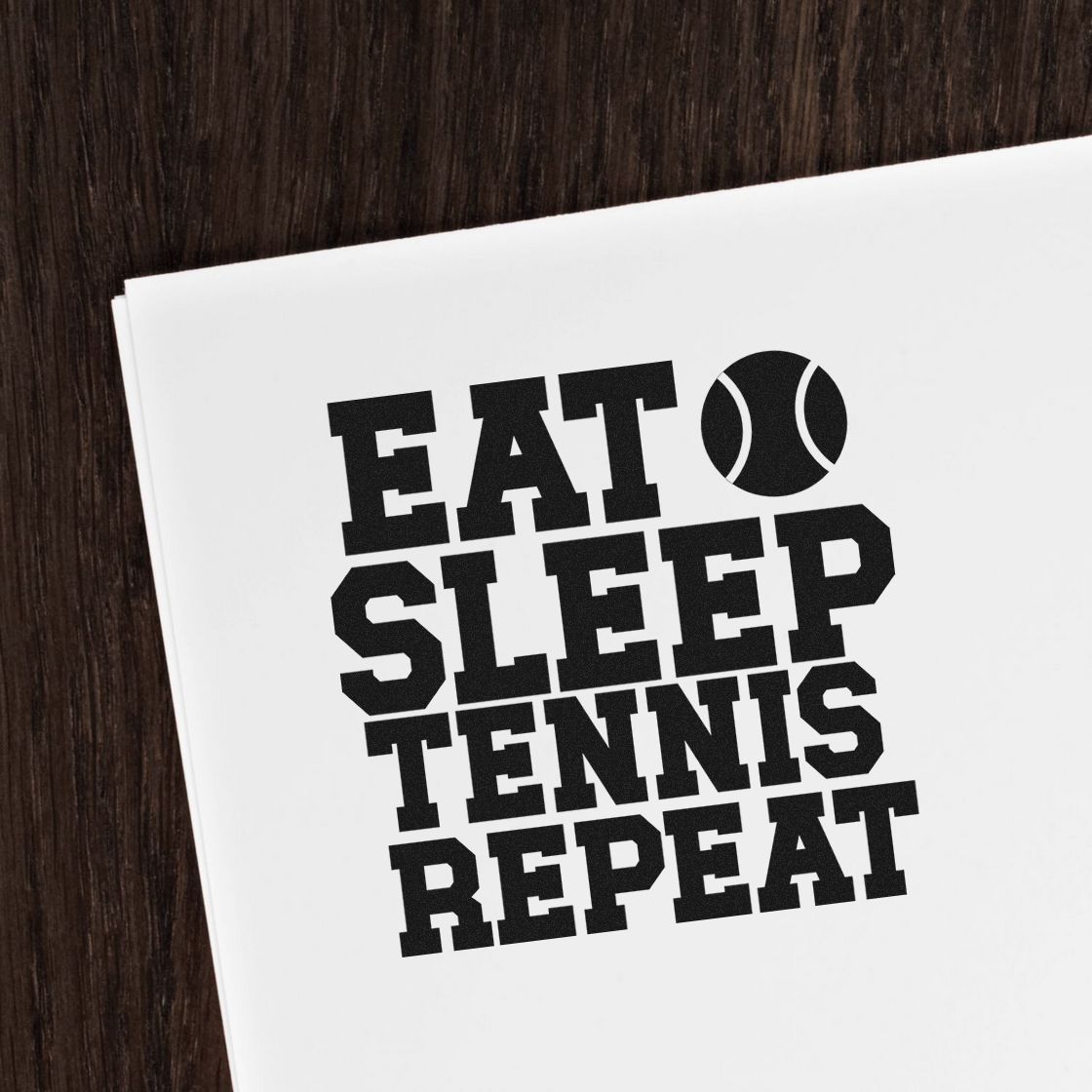 Tennis rubber stamp design reading Eat Sleep Tennis Repeat with a tennis ball icon on white paper.