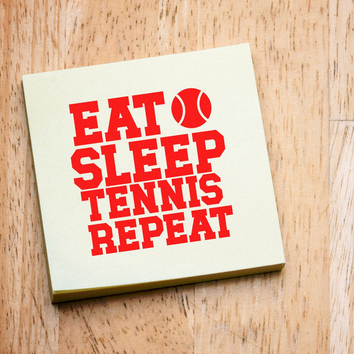 Tennis rubber stamp design with red Eat Sleep Tennis Repeat slogan and tennis ball icon for sports-themed crafts.