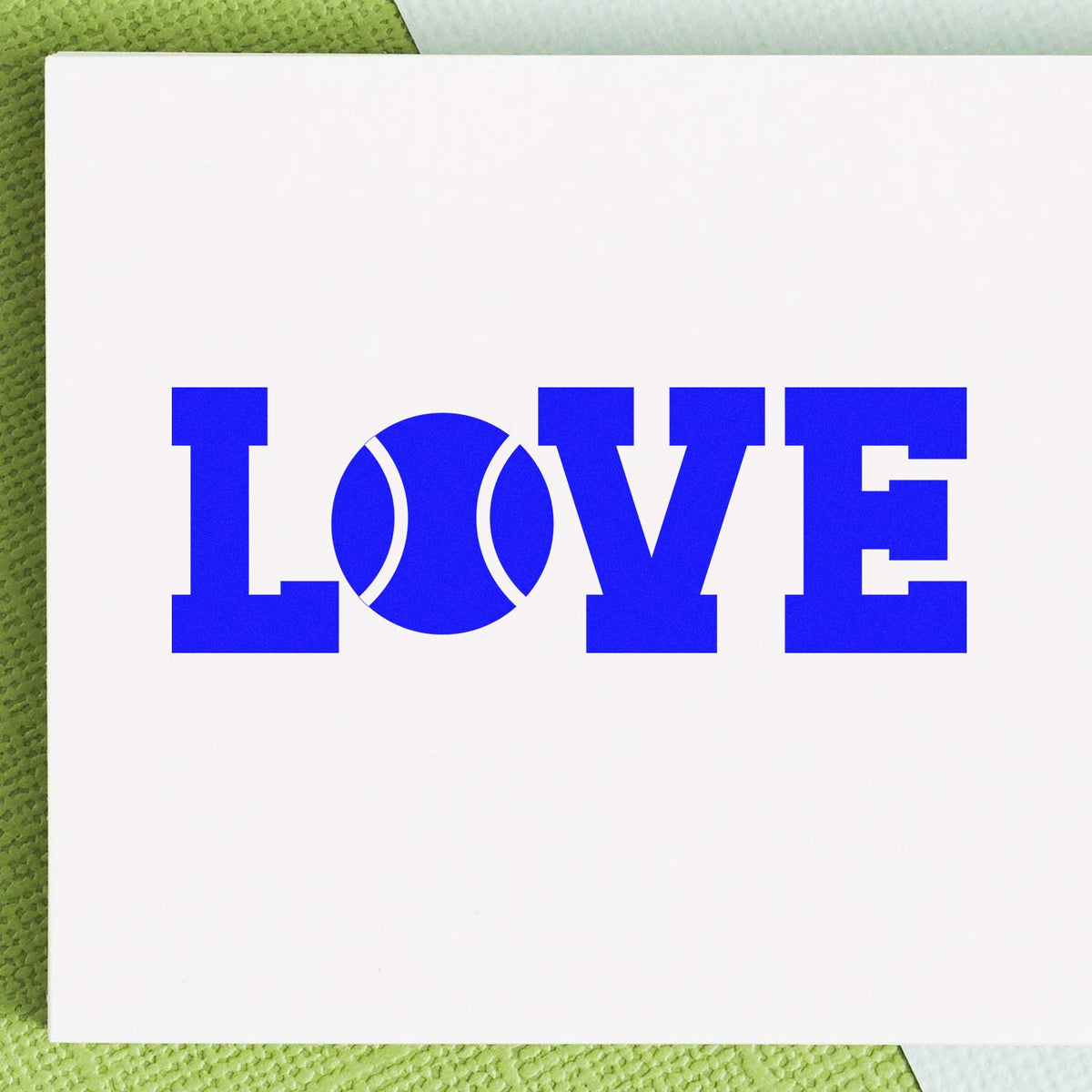Blue LOVE rubber stamp design with a tennis ball as the O, ideal for tennis-themed cards, crafts, and custom stamping.