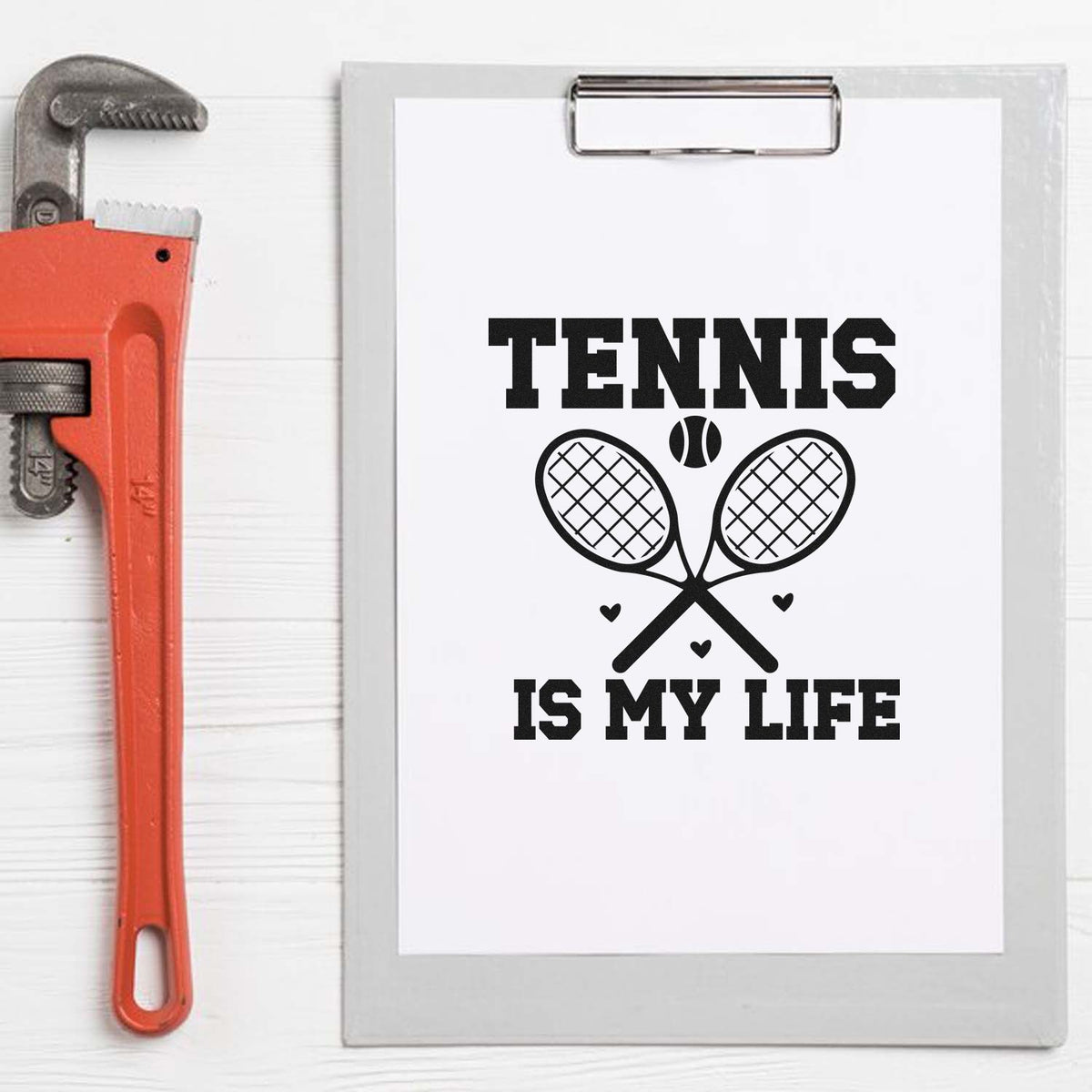 Tennis Is My Life custom rubber stamp design with crossed rackets and ball, displayed on a clipboard beside a pipe wrench.