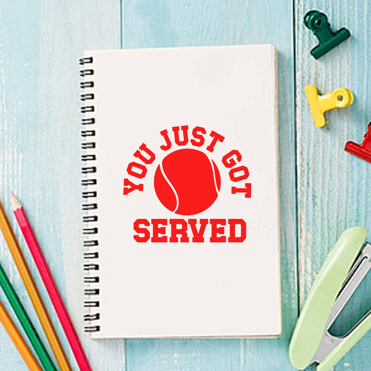 Tennis-themed rubber stamp reading "You Just Got Served" on notebook, perfect for custom stationery and sports-themed gifts.
