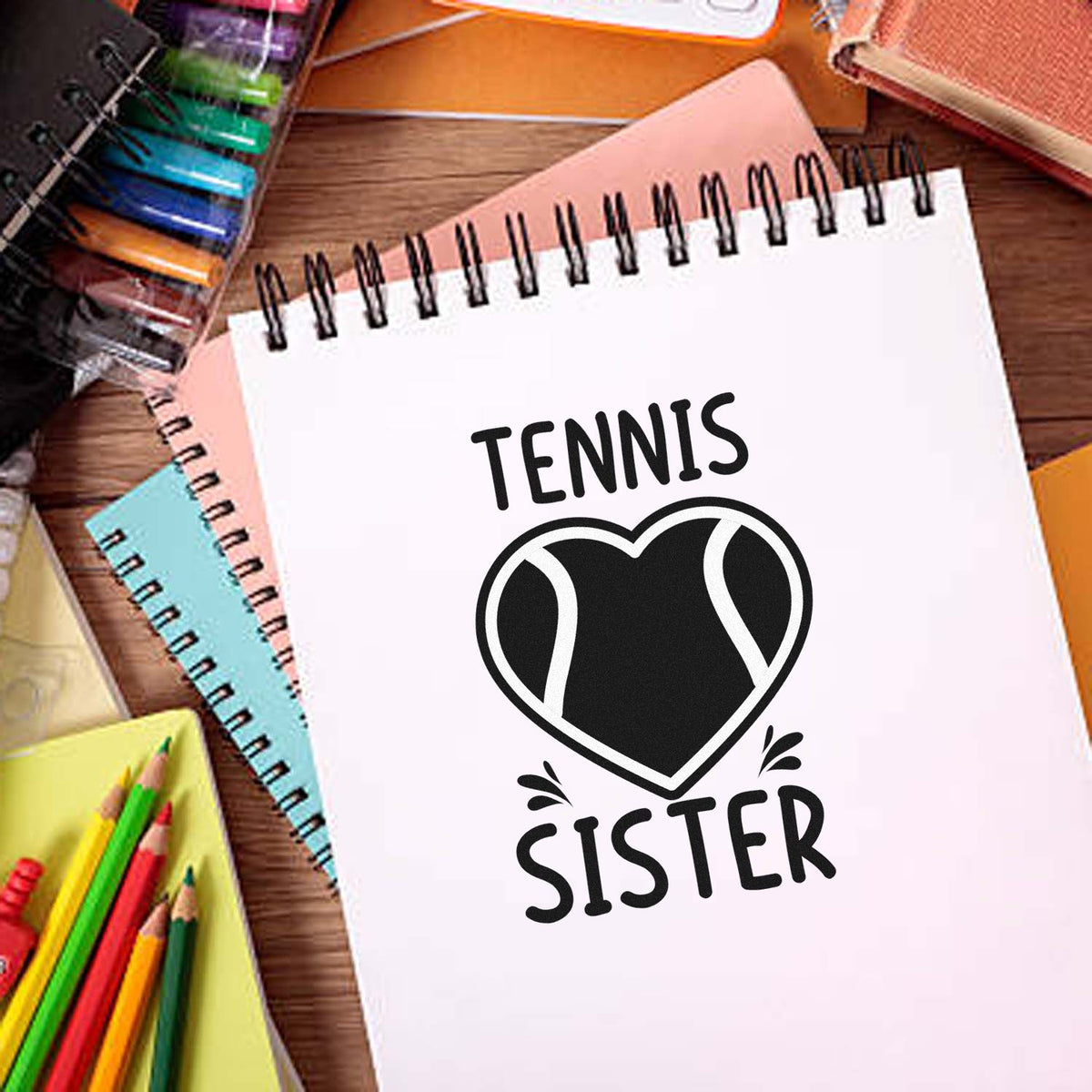 Tennis Sister rubber stamp design on a notebook, featuring a heart-shaped tennis ball graphic for personalized sports gifts.