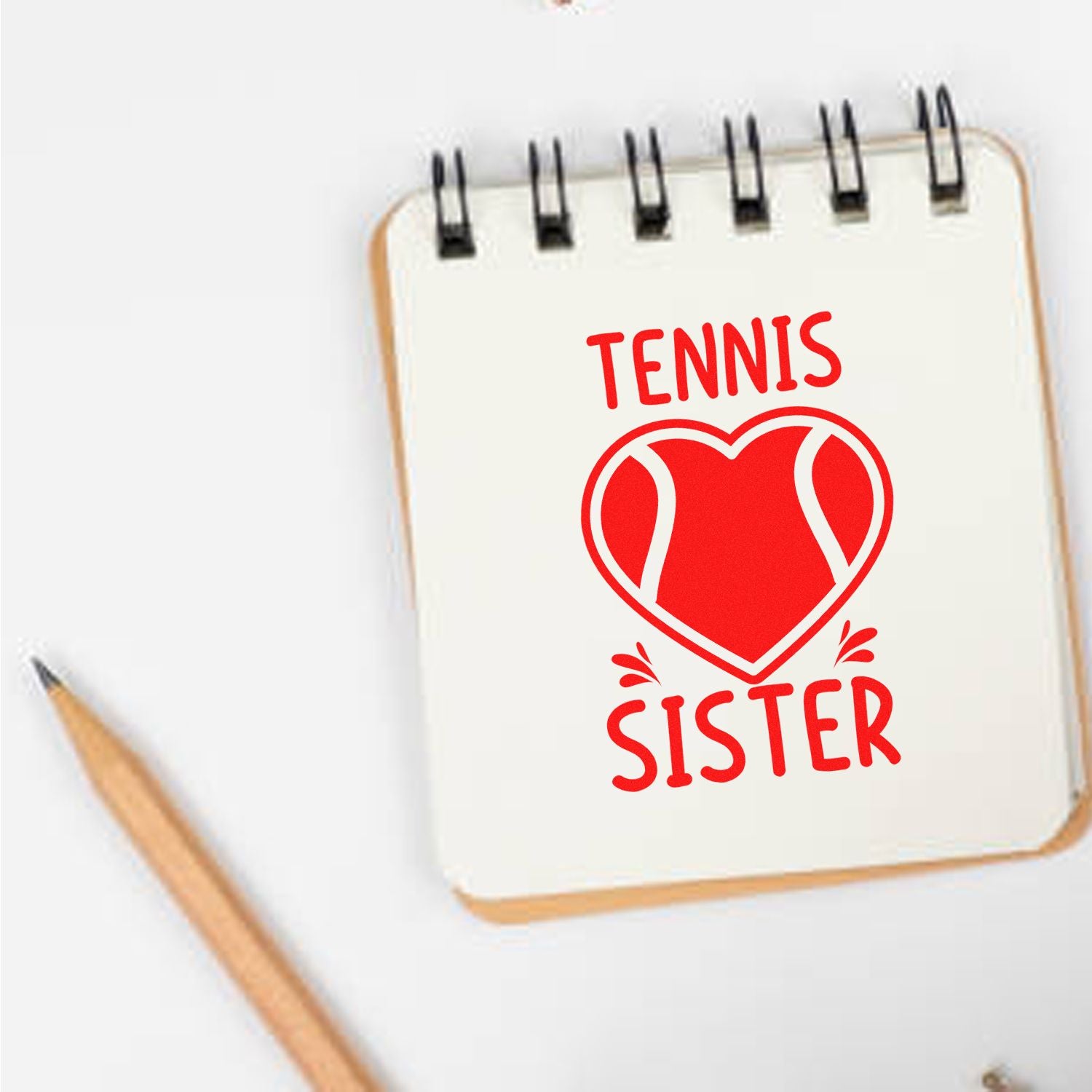 Tennis Sister custom rubber stamp design with heart tennis ball graphic on notebook mockup