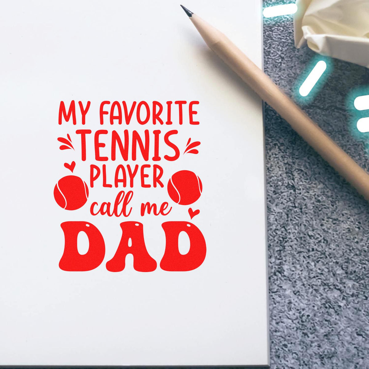 Tennis dad rubber stamp design with red My favorite tennis player call me Dad quote on notebook.