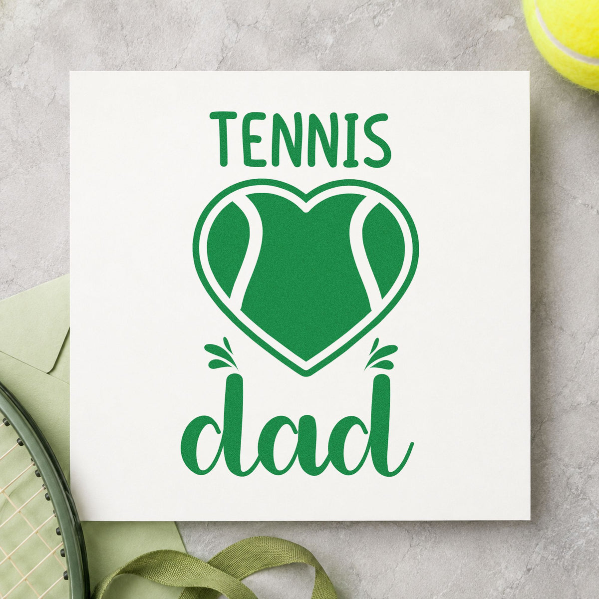 Tennis Dad Heart Ball craft stamp in green ink on cardstock, an easy option for coaching album page.