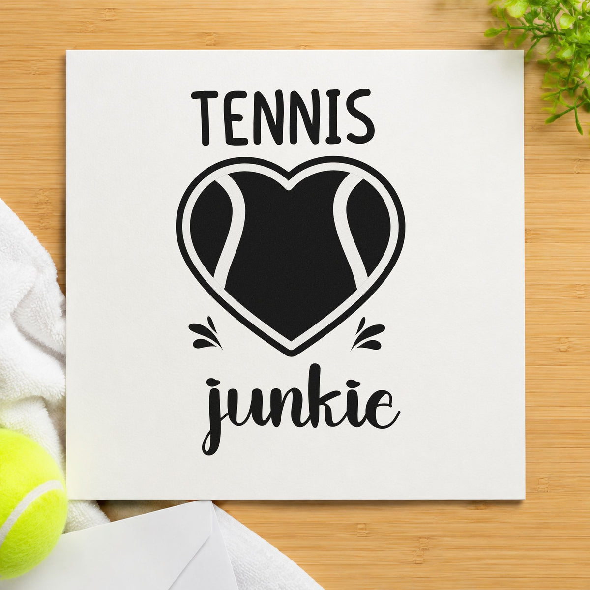 Tennis Junkie Heart Ball craft stamp imprint in black ink on a handmade project, one idea being flask gift tags.