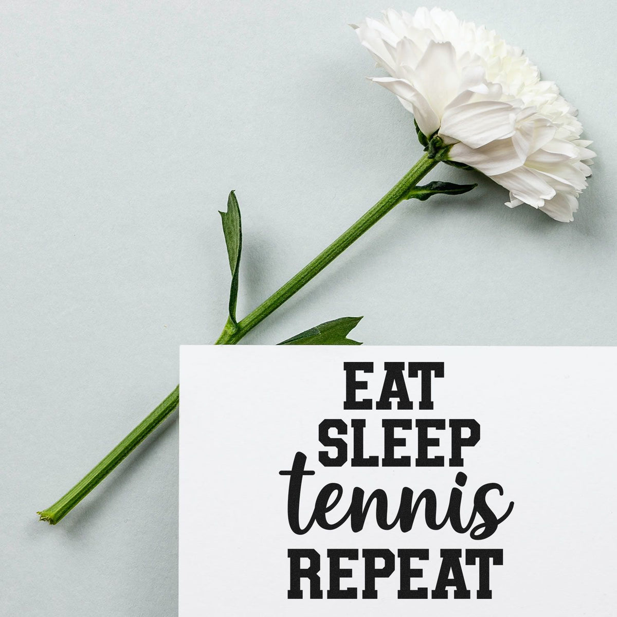 Tennis rubber stamp design with Eat Sleep Tennis Repeat quote on a floral greeting card.