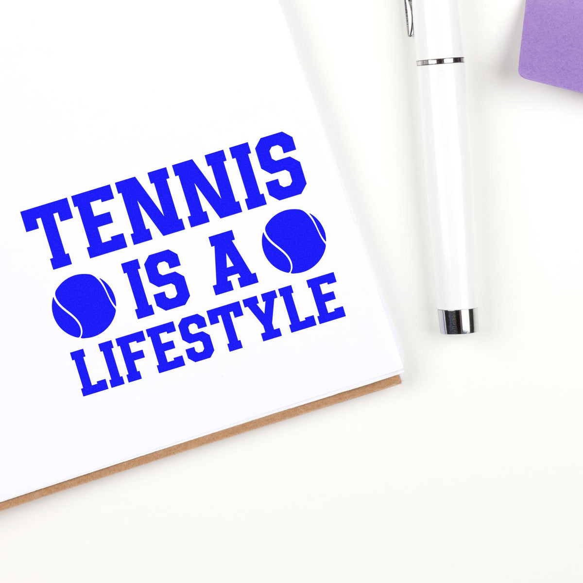 Custom tennis rubber stamp design reading "Tennis is a Lifestyle" with tennis ball icons on a notebook.