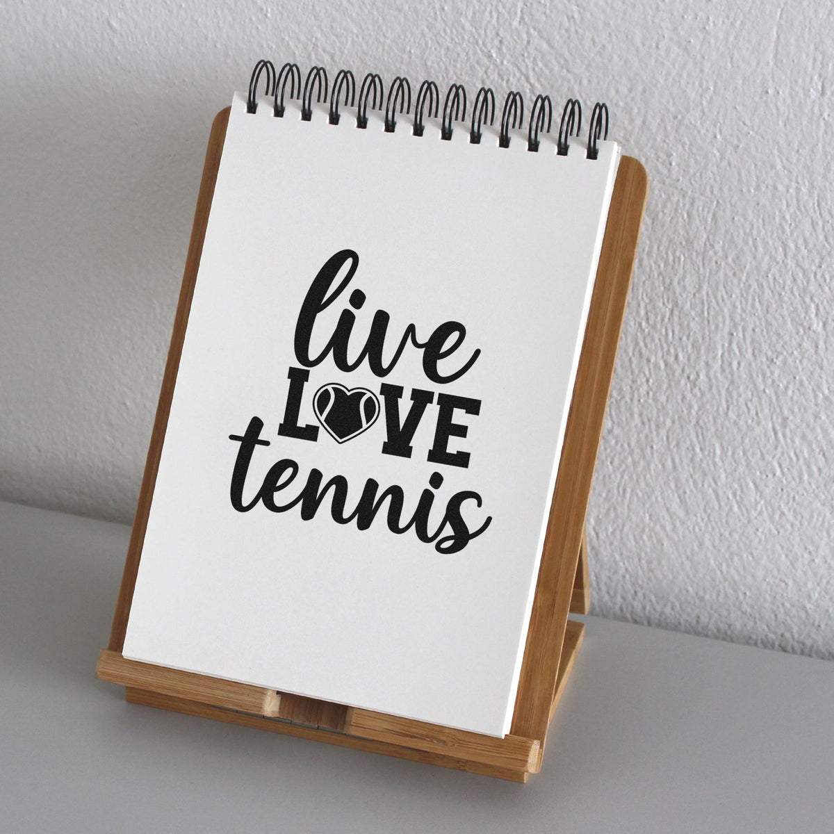 Live Love Tennis PSI Pre-Inked Stamp imprint stamped in black ink. live LOVE tennis uses a heart-shaped tennis ball in place of the O.
