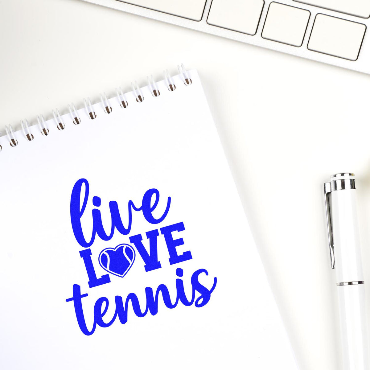 Live Love Tennis Heart rubber stamp shown in blue ink, stamped for projects such as board year album page.